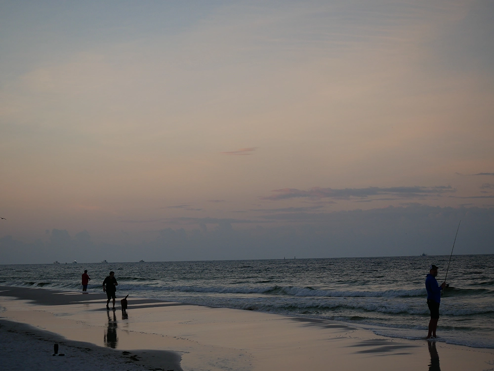 Panama City Beach dusk photo with soft pastel colors in the sky and water reflecting the sunset light.