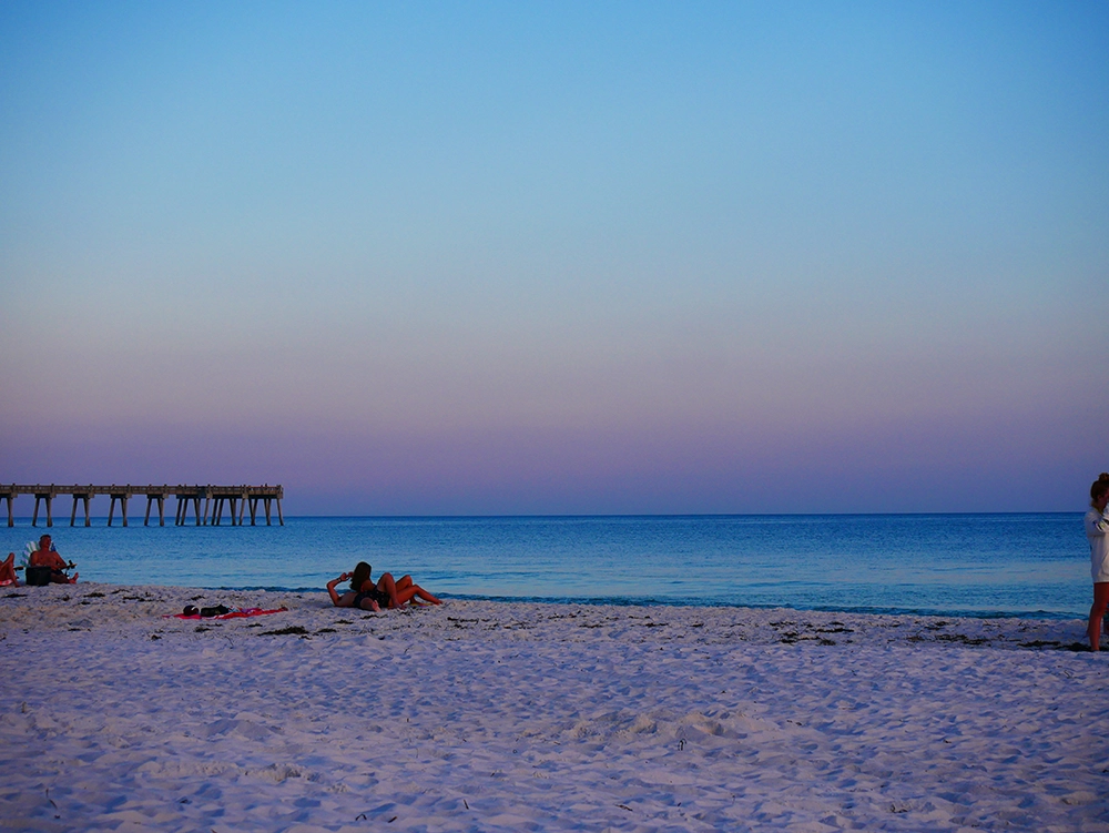 Panama City Beach dusk photo with soft pastel colors in the sky and water reflecting the sunset light.