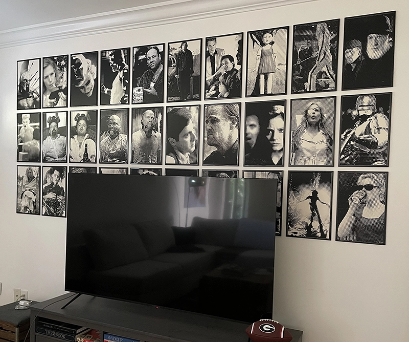 Movie Series screen prints displayed together on the entertainment wall.